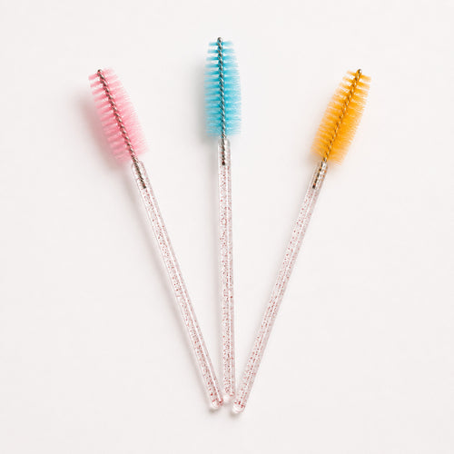 Pink, blue and yellow disposable eyelash spoolie brush detail